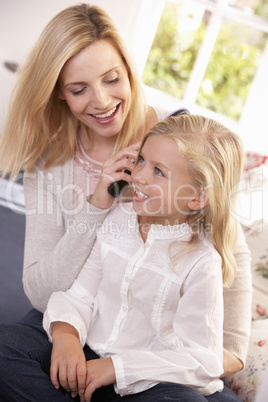Woman combs hair of young girl