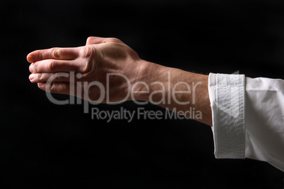 Fist. Hand fighter karate on the black background