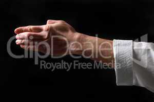 Fist. Hand fighter karate on the black background