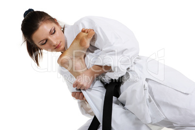 Karate. Young girl in a kimono with a white background