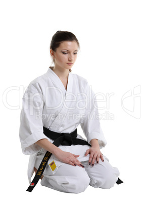 Karate. Young girl in a kimono with a white