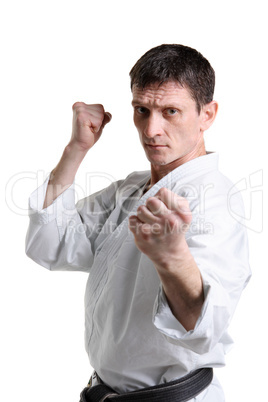 Karate. Man in a kimono with a white background