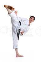 Karate. Man in a kimono hits foot on the white
