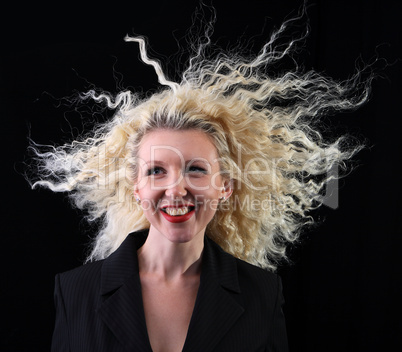 Pretty curly blonde on a black. Hair in the wind