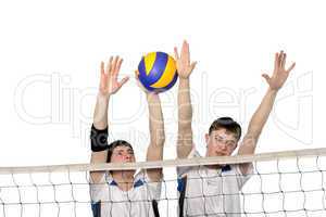 Volleyball players with the ball on a white