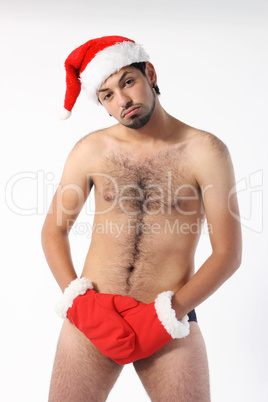 Sexy muscular man wearing a Santa Claus hat isolated on white