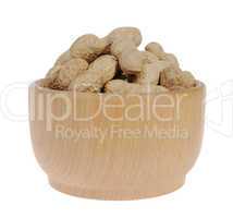 peanuts in a wooden mortar and spilled on the white