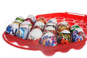 Colorful painted Easter eggs in a red plastic tray