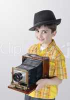 Little boy with an old camera