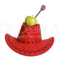 Green apple with a dart in a red hat on the white background