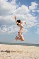 Girl jumping on the beach