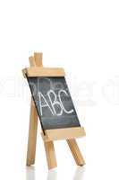 Angled chalkboard with the letters abc written on it