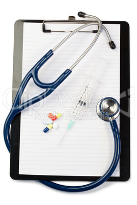 Note pad wth blue stethoscope and pills