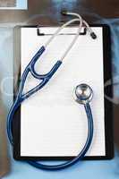 Note pad and blue stethoscope