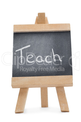 Chalkboard with the word teach written on it