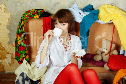 Attractive woman sitting in a suitcase