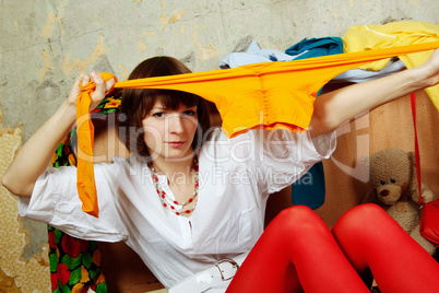 Attractive woman sitting in a suitcase