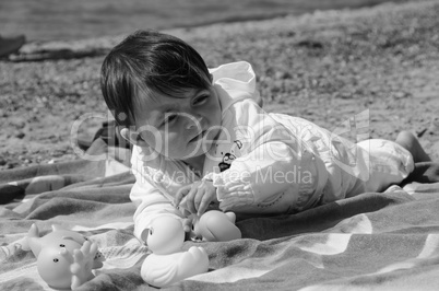 Baby Girl relaxing and playing on a Beach Towel