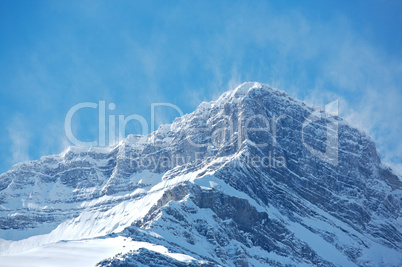 Snow spindrift on mountain peak 03