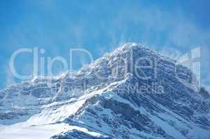 Snow spindrift on mountain peak 03