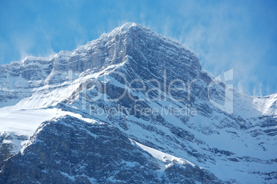 Snow spindrift on mountain peak 04