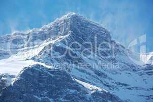 Snow spindrift on mountain peak 04