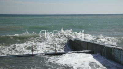 Seafront and pier with huge waves