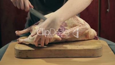Cook cut up raw turkey into pieces with a knife