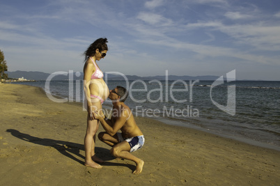 Pregnant Woman with her Husband at Seaside