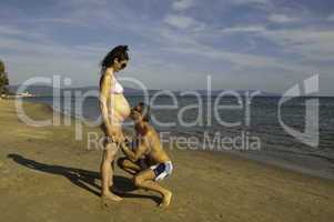 Pregnant Woman with her Husband at Seaside