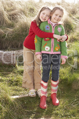 Young Girls Playing In Field Together