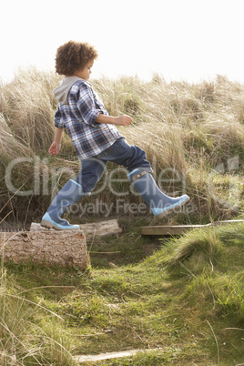 Young Boy Going For Walk In Wellington Boots