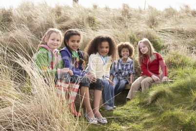 Group Of Children Playing In Field Together