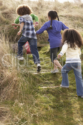 Group Of Children Playing In Field Together