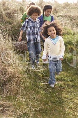 Group Of Children Playing In Field Together