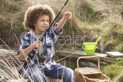 Young Boy Fishing At Seaside