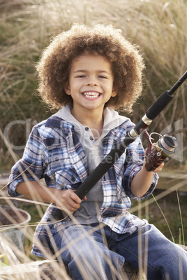 Young Boy Fishing At Seaside