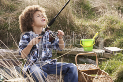 Young Boy Fishing At Seaside