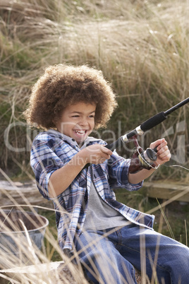 Young Boy Fishing At Seaside