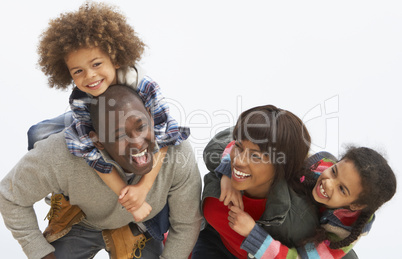 Young Family Relaxing On Beach Camping Holiday