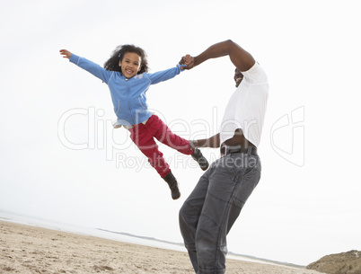 Young Family Relaxing On Beach Camping Holiday