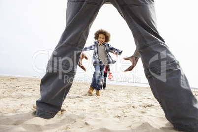 Young Family Relaxing On Beach Camping Holiday