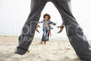 Young Family Relaxing On Beach Camping Holiday