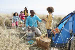 Young Family Relaxing On Beach Camping Holiday