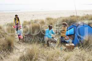 Young Family Relaxing On Beach Camping Holiday