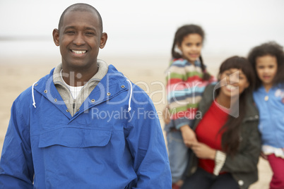 Family Relaxing On Winter Beach Break