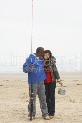 Couple Fishing On Beach