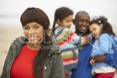 Family Relaxing On Winter Beach Break