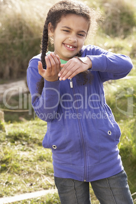 Young Girl Holding Worm Outdoors