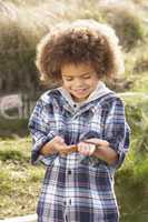 Young Boy Holding Worm Outdoors